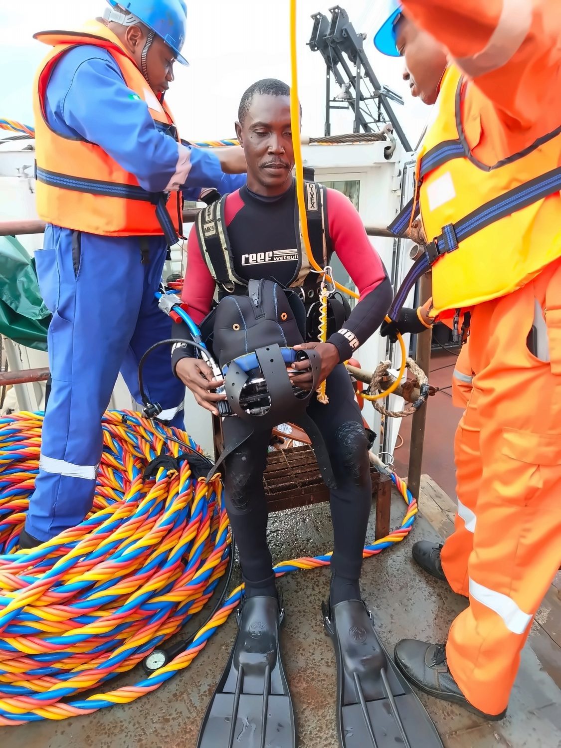 Dive Marine tenders preparing a commercial diver on deck before an inspection dive